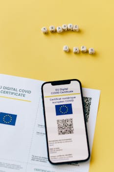 EU Digital COVID certificate with phone on yellow backdrop symbolizes travel safety.