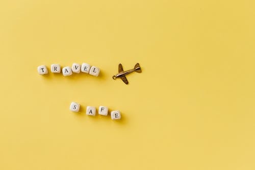 Beads with Letters Arranged in a Text Saying "Travel Safe" and a Small Pendant in a Shape of an Airplane 