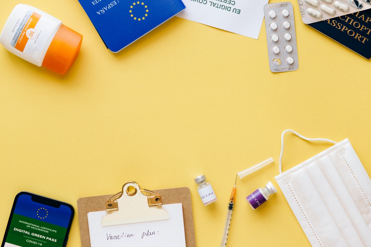 Travel documents, phone and checklist laid out on a desk