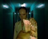 Man in Brown Coat Holding Banknote
