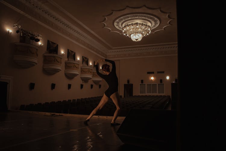 Back View Shot Of A Woman Dancing On The Stage Of A Theater