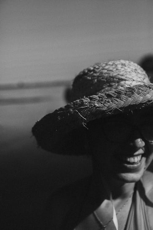 Black and White Photo of Woman in a Straw Hat 