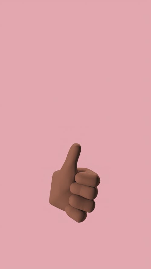 A Hand Doing Thumbs Up Sign on a Pink Background