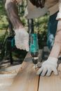 Person Holding Green and Black Cordless Power Drill