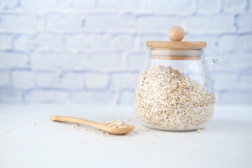 Free Oats on Glass Container with Wooden Lid Stock Photo