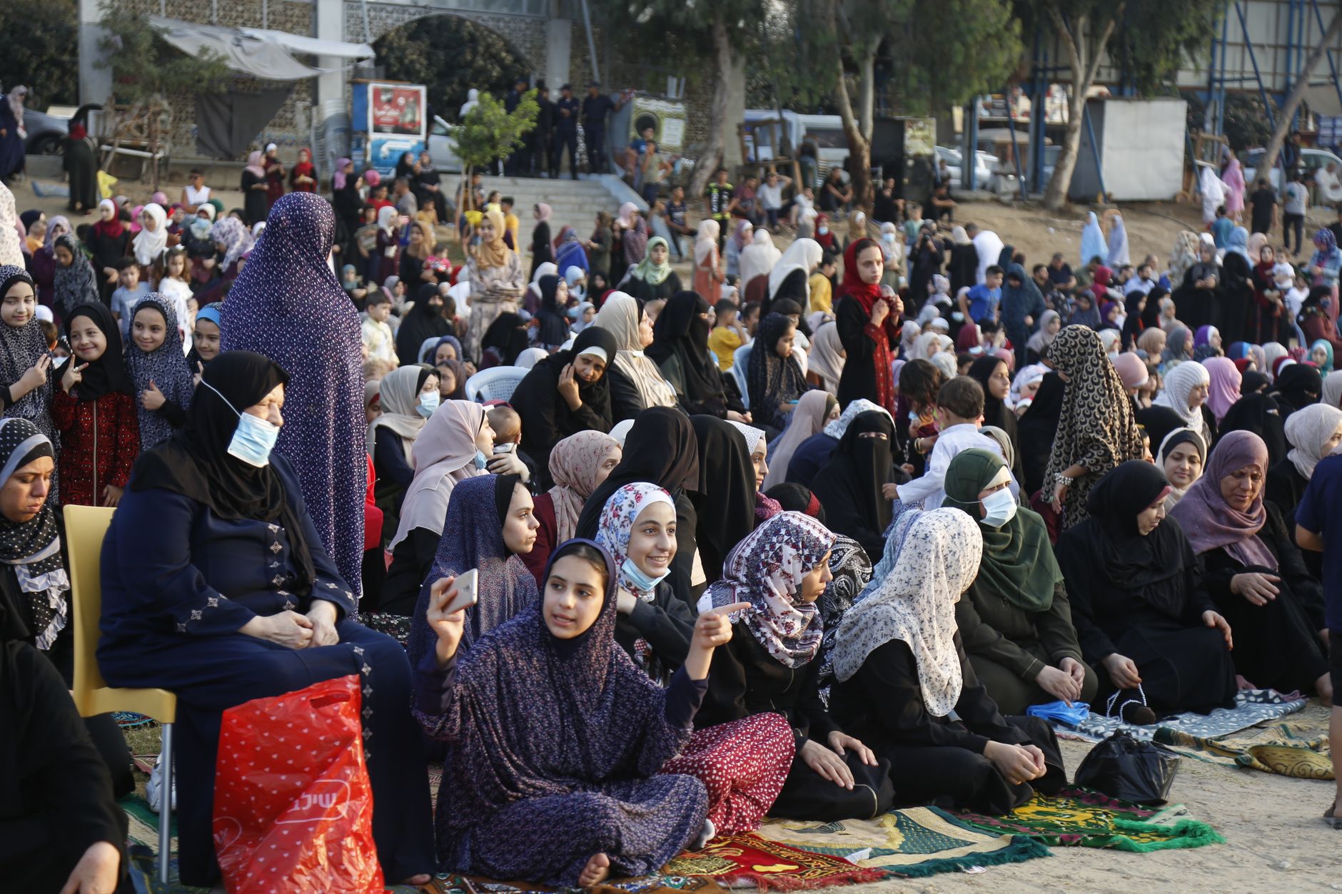 Vibrant crowd celebrating Eid prayers outdoors in Gaza City, showcasing Palestinian traditions.