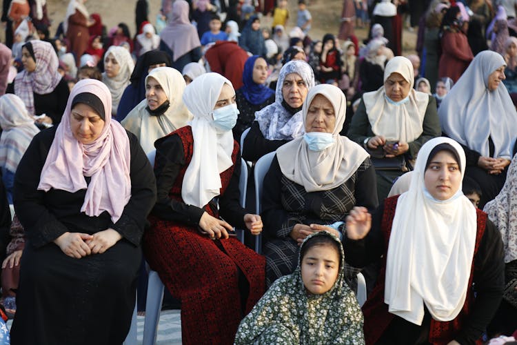 Group Of Women In Hijabs Sitting Praying 