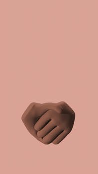 A 3D illustration of a handshake emoji on a soft pink background, symbolizing unity and agreement.