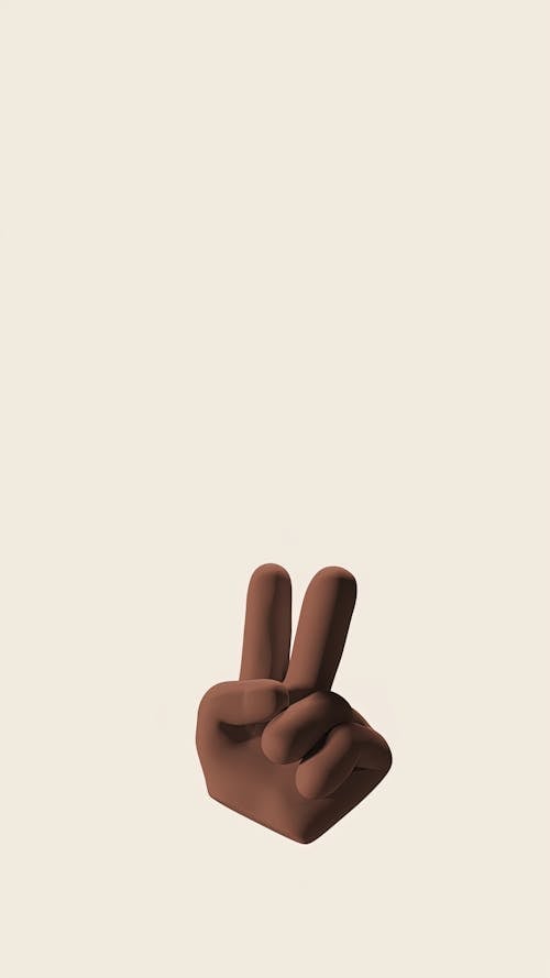 Persons Hand Doing Peace Sign in White Background