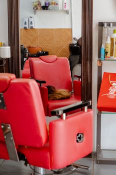 Vibrant red barber chairs in a modern salon, reflecting style and comfort for professional grooming.
