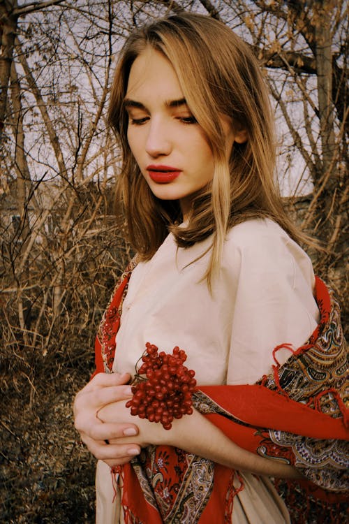 Woman Wearing a White Dress with Red Scarf