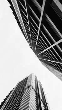 Low angle view of modern skyscrapers in monochrome, Dubai's architectural skyline.