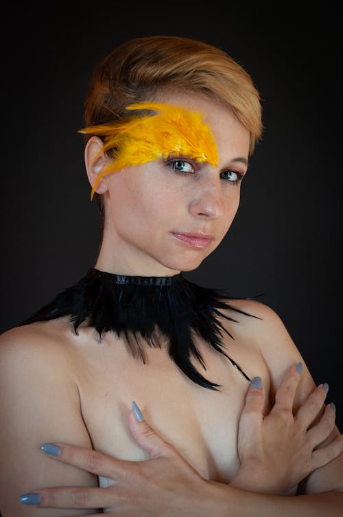 Topless Woman with Feathers on Her Face