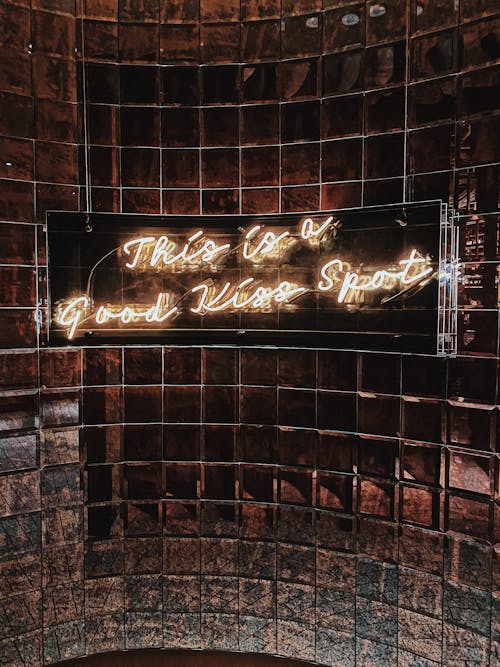 Brown Tiled Wall with Neon Sign