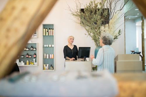 Hair Dresser and a Client Talking Inside a Salon