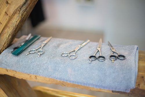 Free Close-up of hairdressing scissors on a towel in a salon setting, showcasing precision tools. Stock Photo