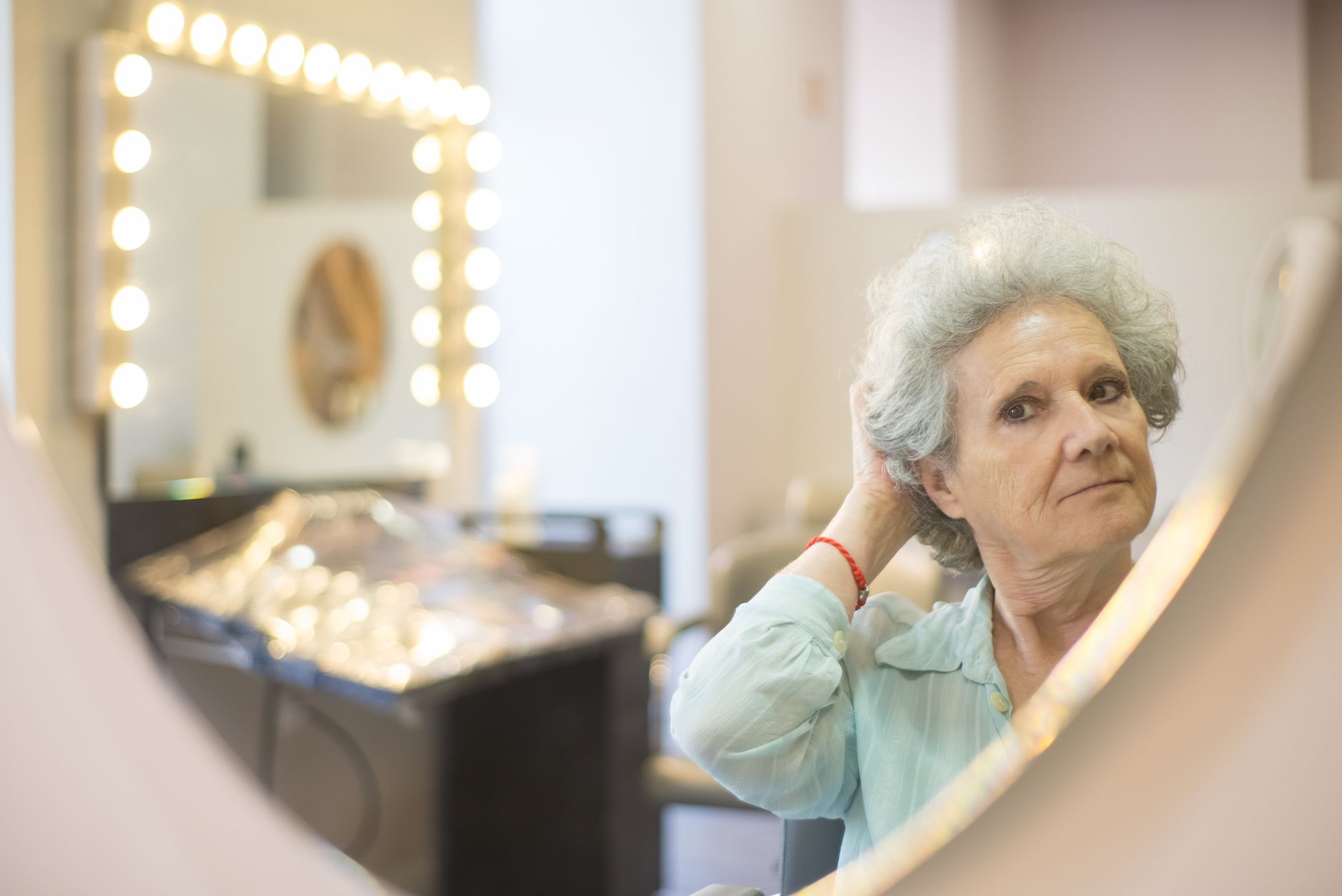 mature woman looking mirror