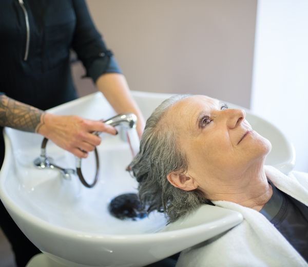 Salon stylist working on a client's hair
