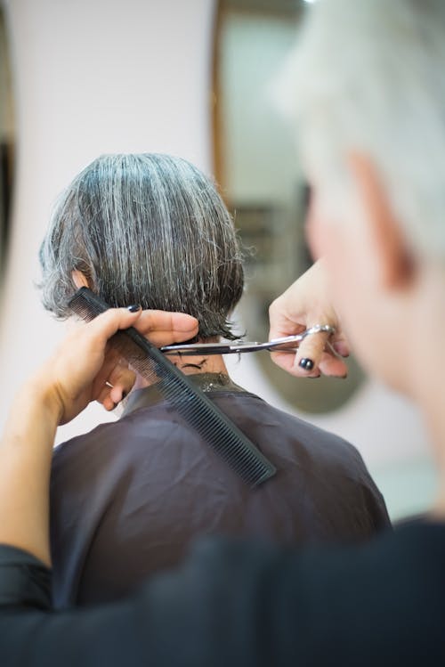 Free Person Cutting Hair with Scissors Stock Photo