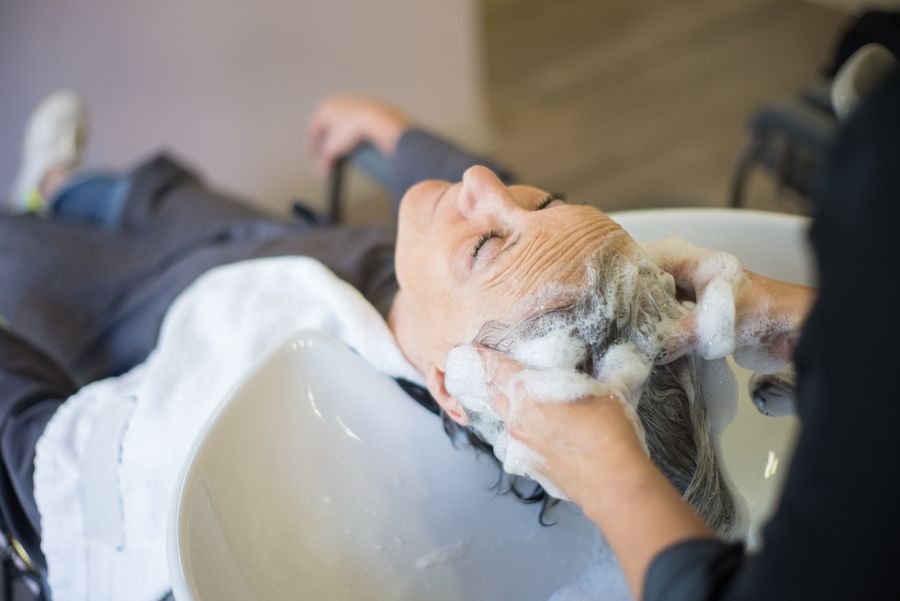Client receiving a scalp treatment in a salon