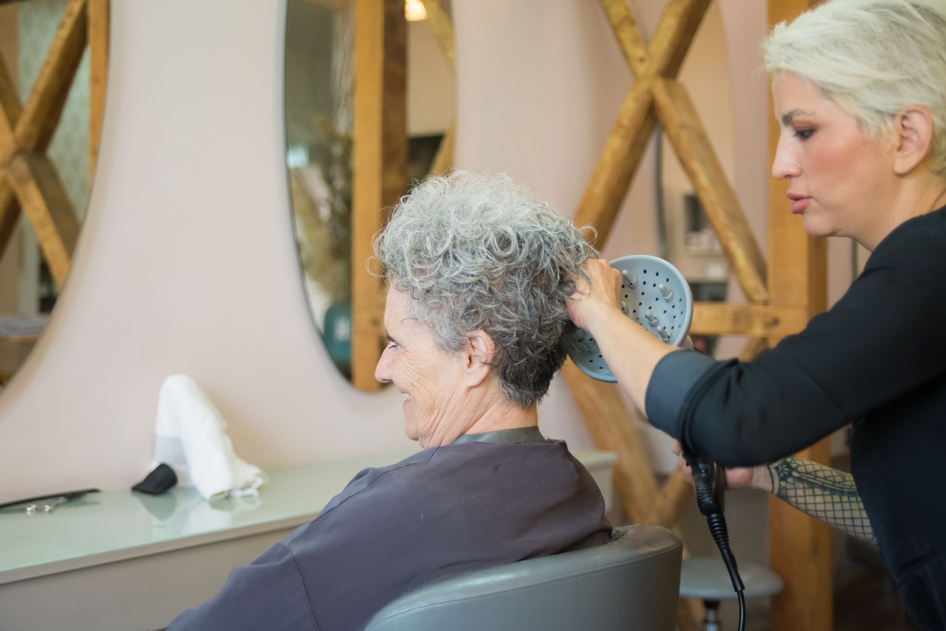 Woman Drying the Hair of an Elderly Woman