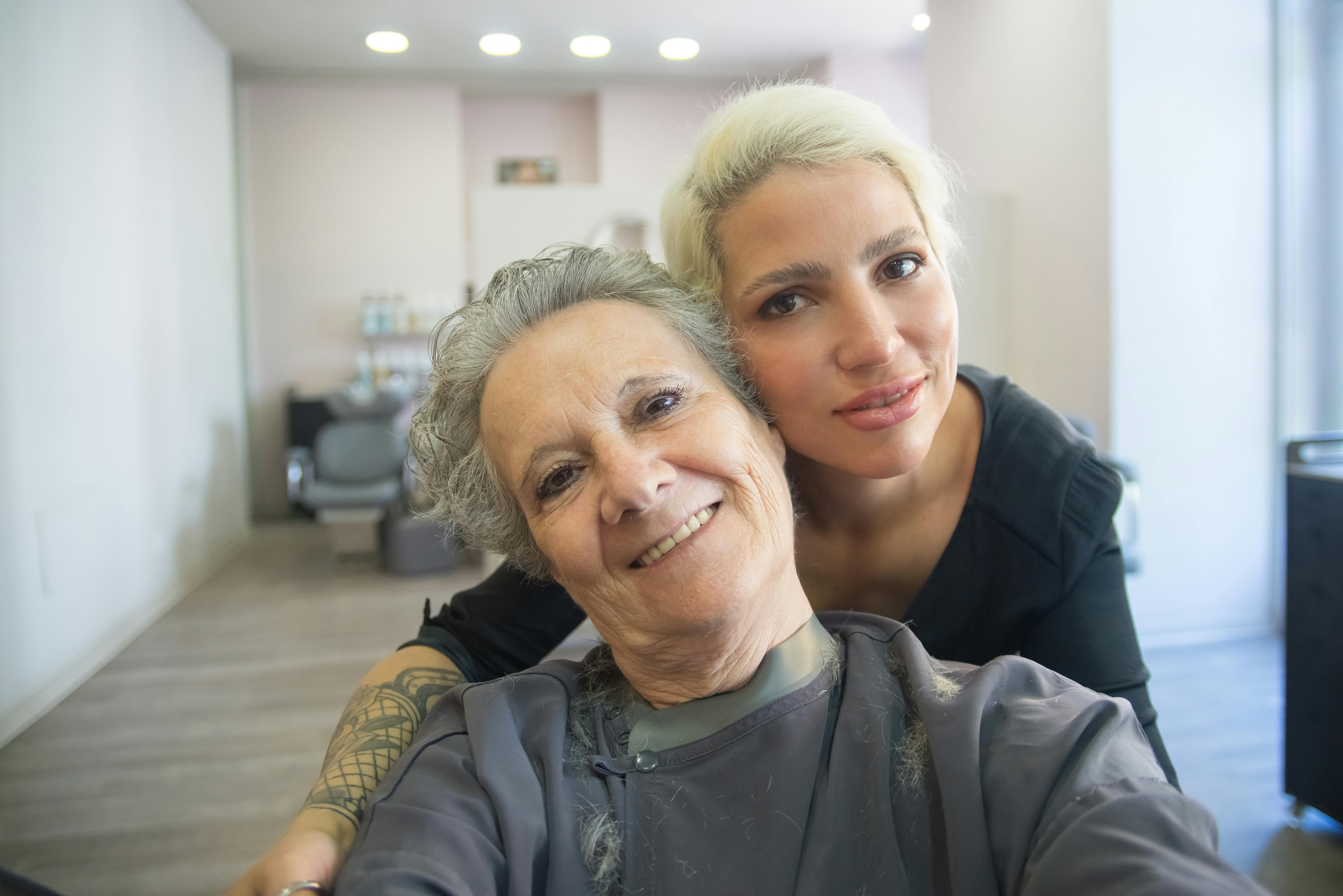 happy client consulting with a friendly stylist or barber - beauty salons in utah