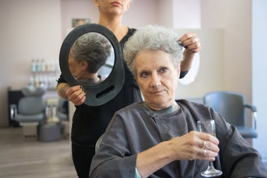 Senior woman enjoys a stylish haircut at a salon in Portugal, savoring a drink.