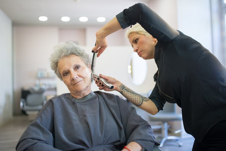 Hairstylist Shaving The Hair Of The Customer Using A Razor