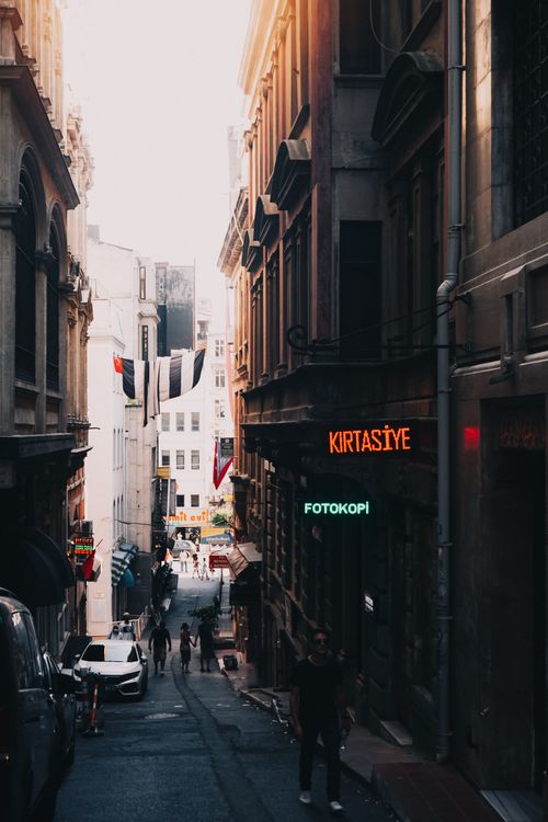 Free View of a lively street in İstanbul with people walking and classic architecture in warm evening light. Stock Photo
