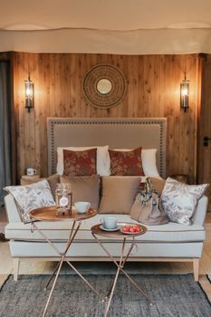 Elegant bedroom setup showcasing modern furniture and warm decor for a cozy atmosphere.