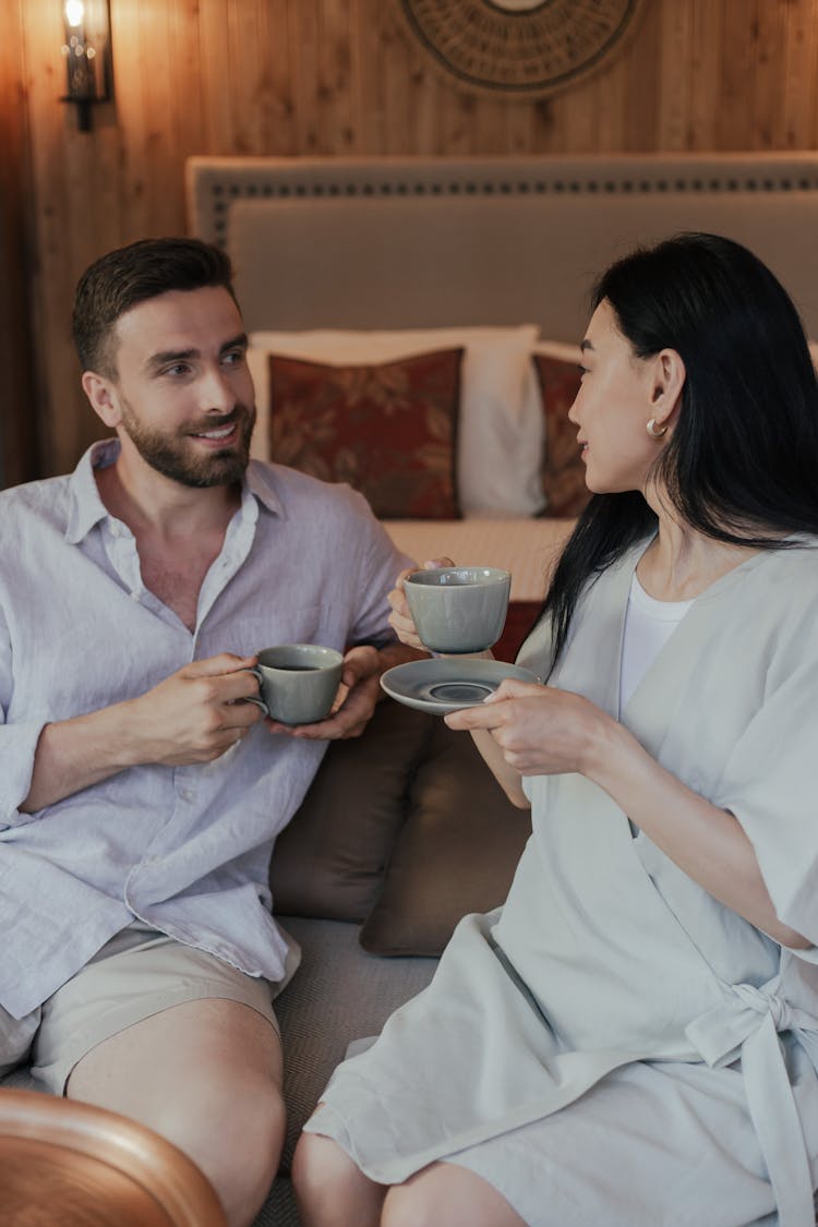 Man And Woman Holding Cups