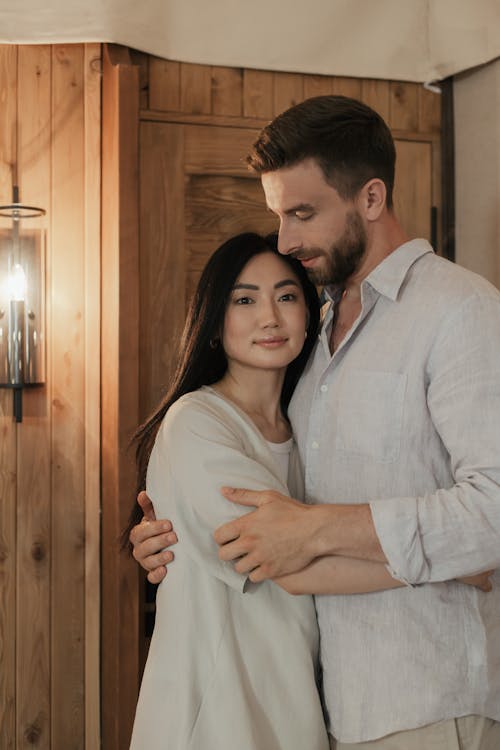 Couple in White Outfit Hugging 