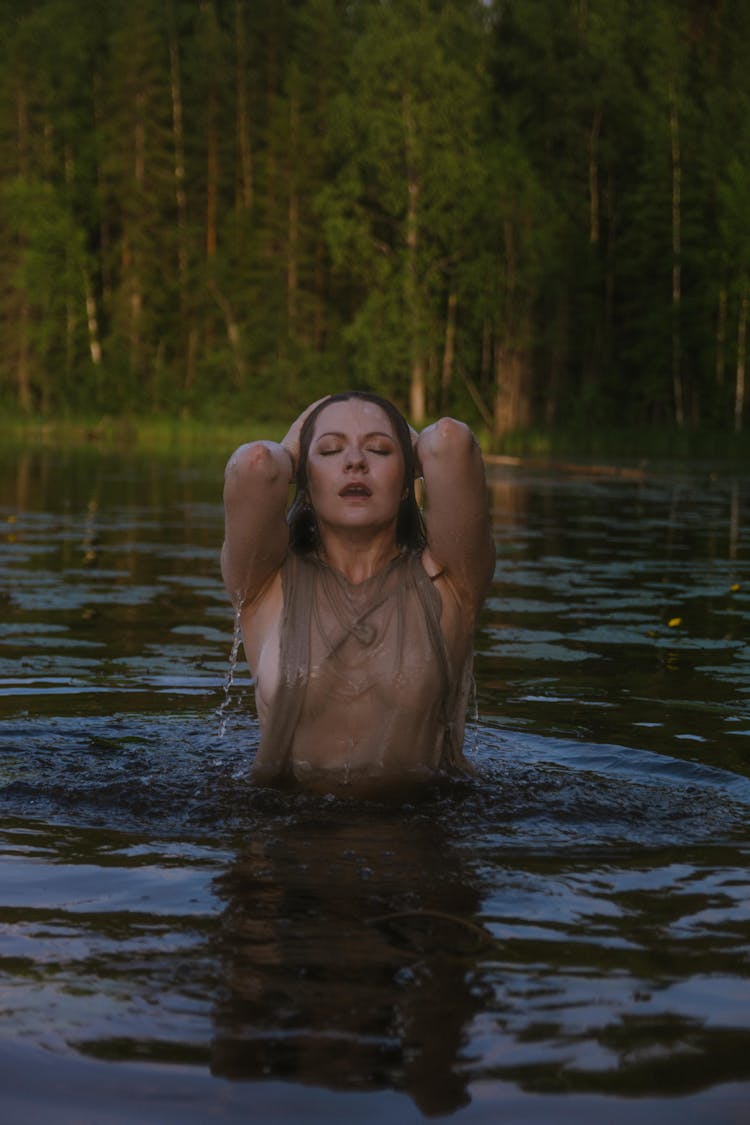 A Woman Swimming In The Lake