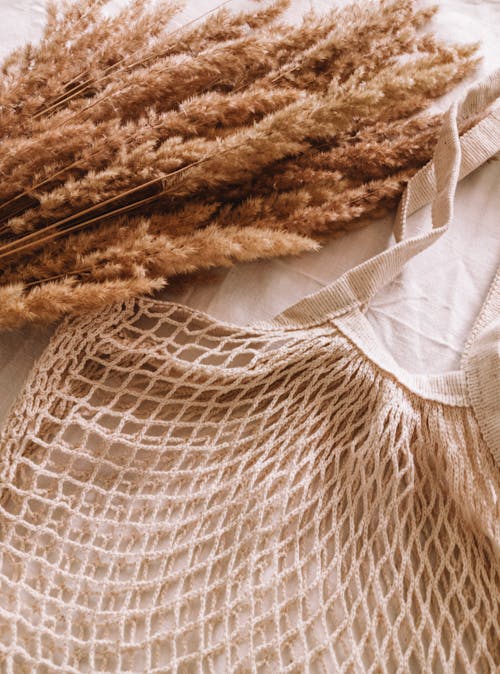 Close-Up Shot of a Wheat and a Knitted Textile