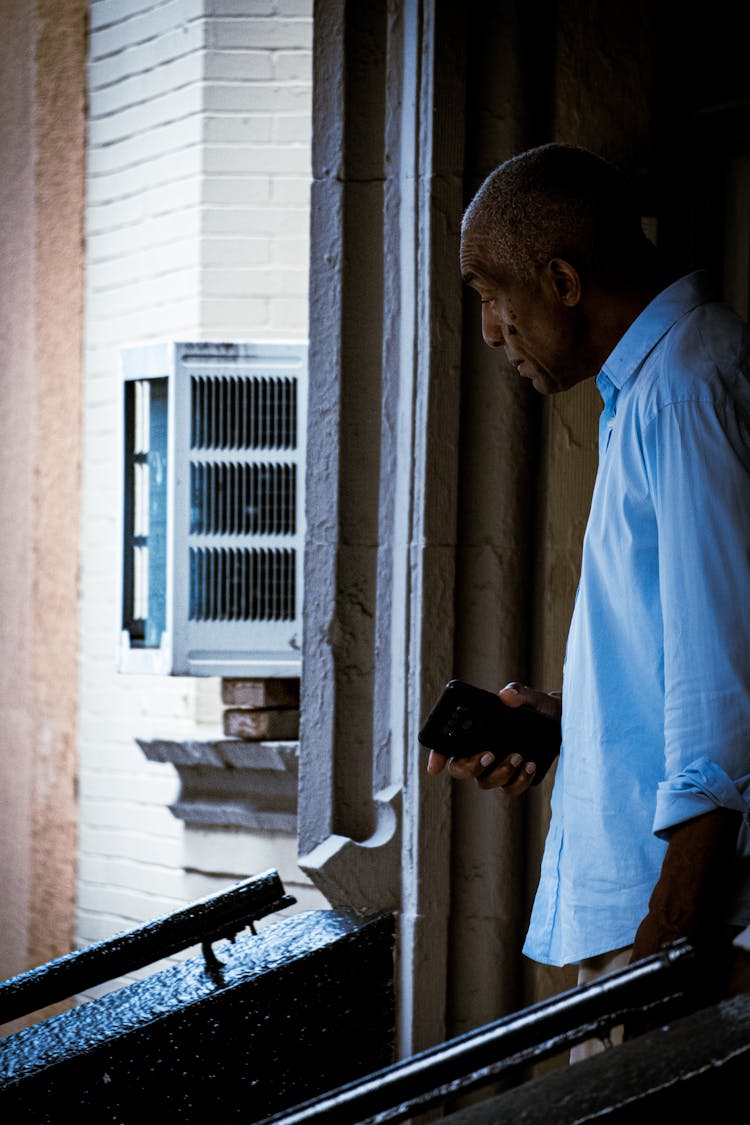 A Man Looking Out The Window