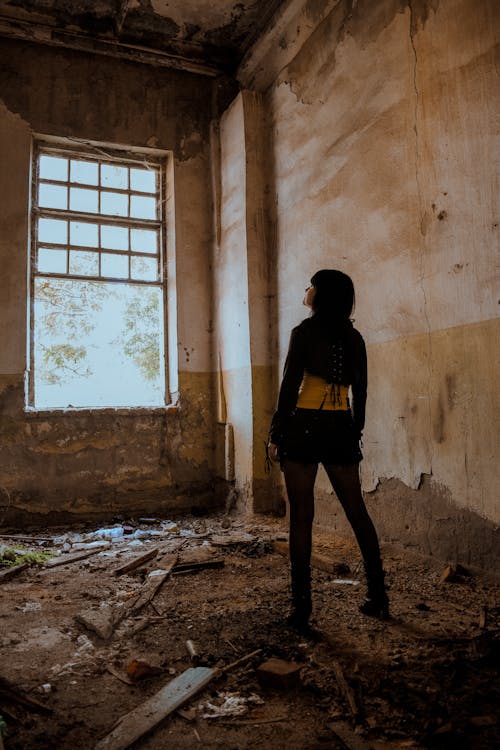 Free Woman Alone in an Abandoned Building Stock Photo