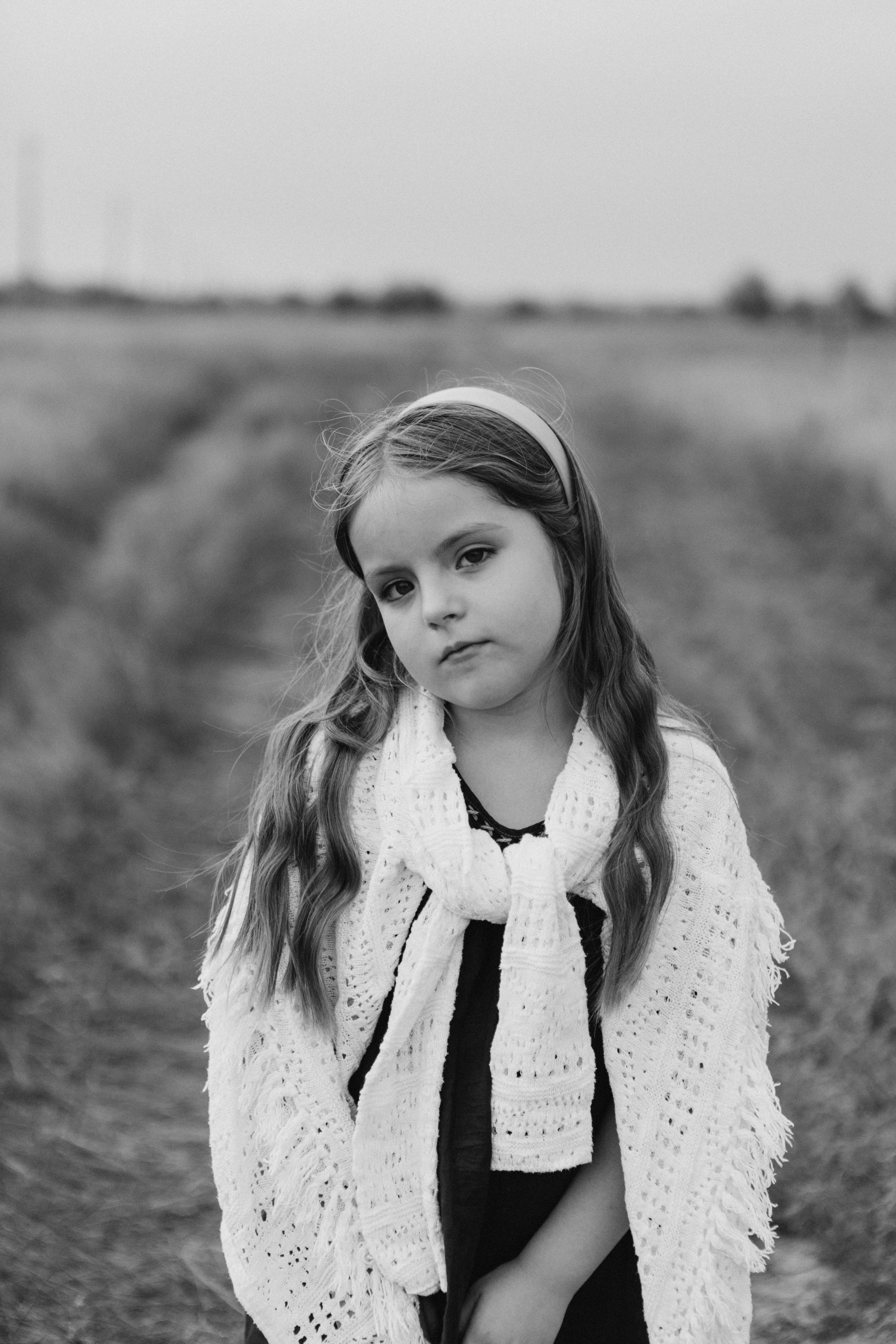 Grayscale Photo of Woman Standing on Grass Field · Free Stock Photo