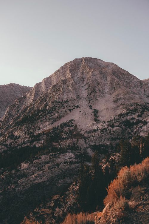 Free Stunning view of a rugged mountain peak with soft sunset lighting. Stock Photo