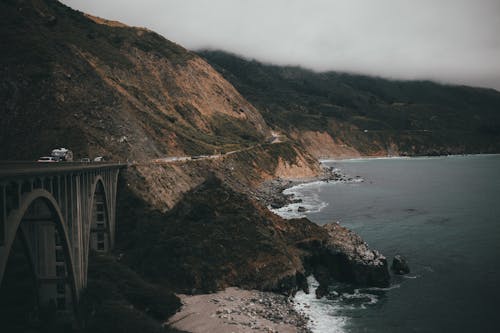 Concrete Bridge on the Mountain Near Body of Water