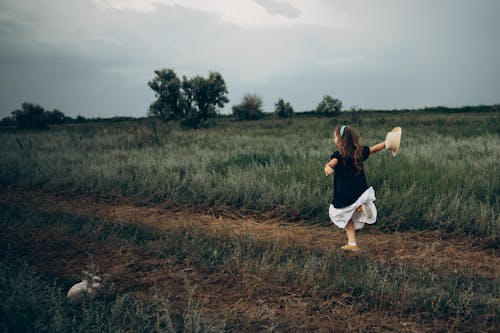 Little Girl Running on Grass Field