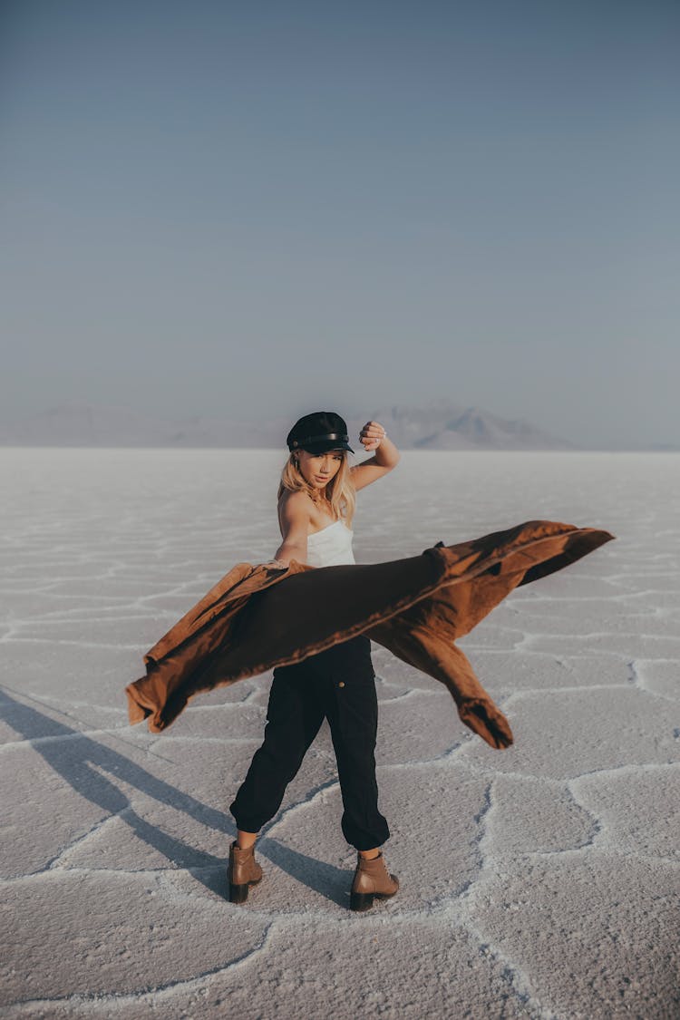 Woman Standing In Badwater And Throwing Her Jacket 