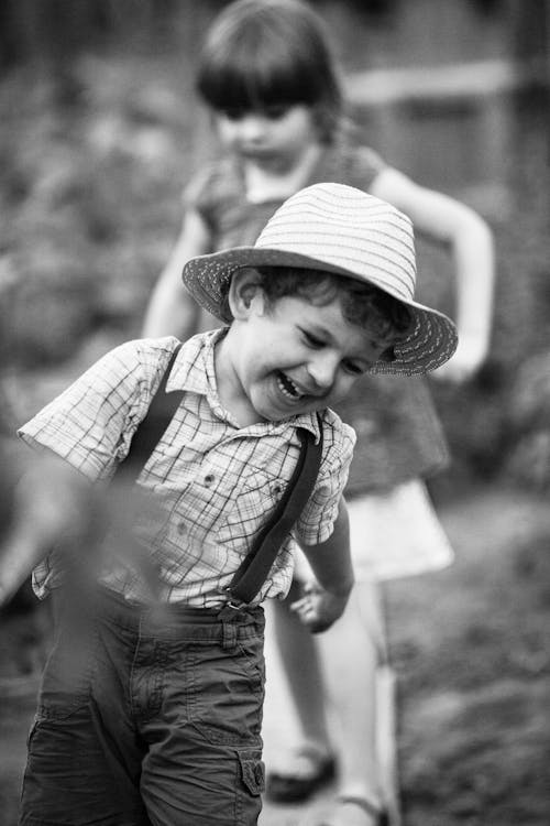 Free Black and White Photo of a Young Boy Laughing Stock Photo