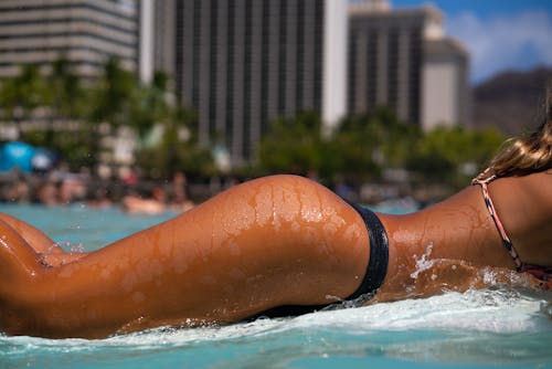 Woman in Black Bikini Bottom in a Swimming Pool