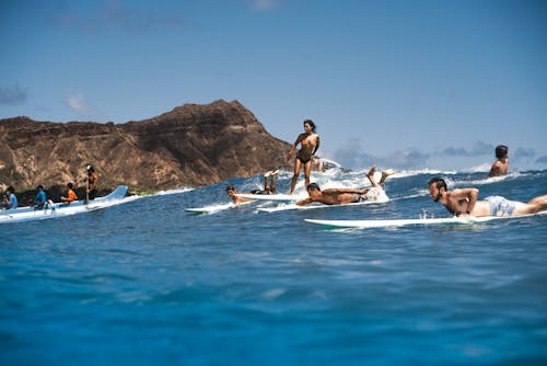 People Surfing in the Sea