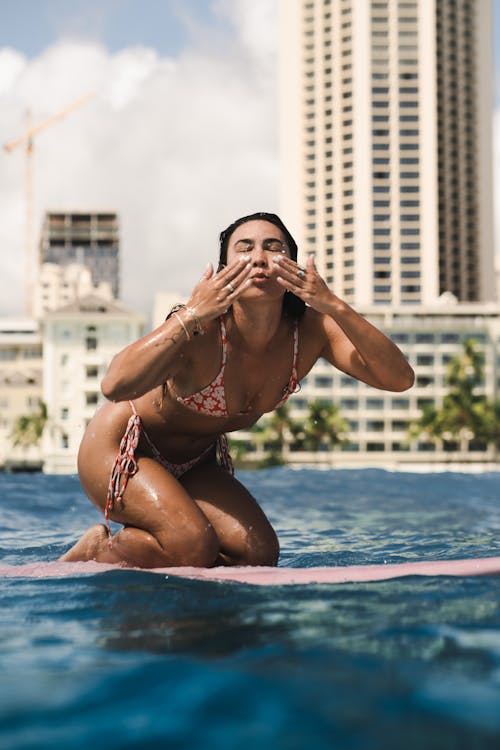 Woman Kneeling on a Surfboard