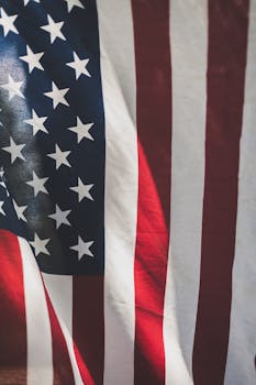 A detailed view of the American flag highlighting stars and stripes in sunlight.