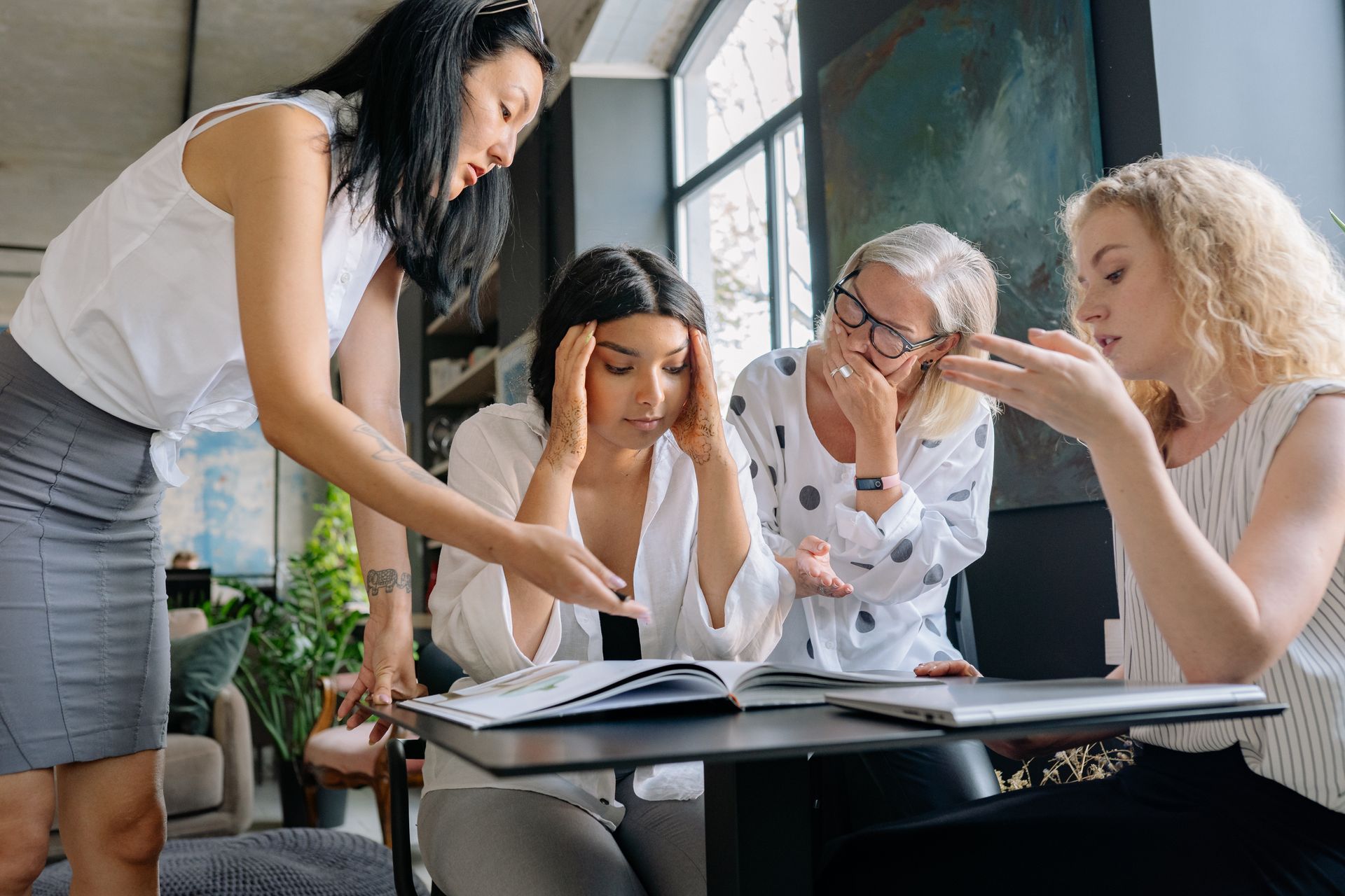 Group of women in a modern office environment collaborating on a project together.