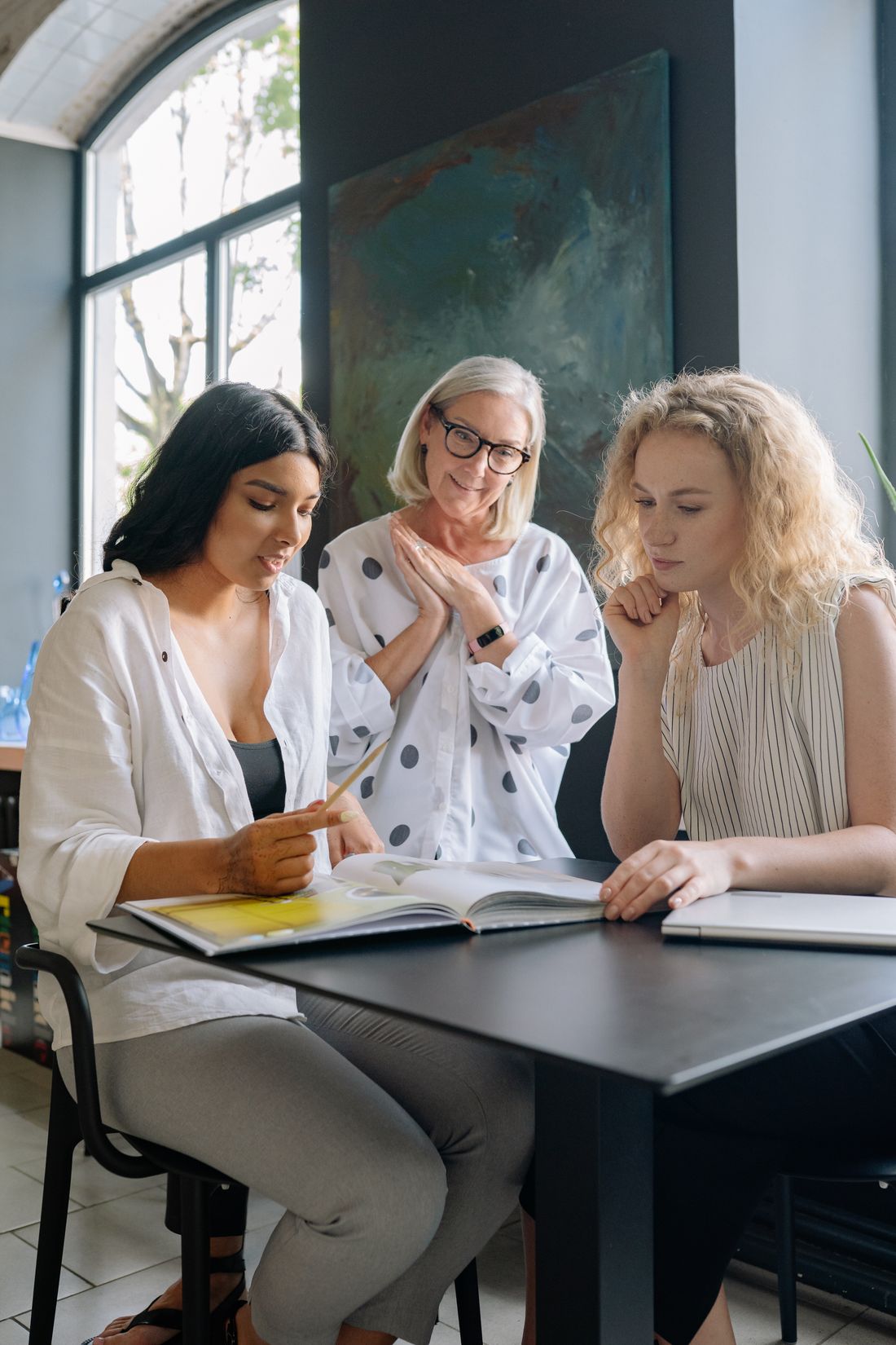 A publisher and two authors reviewing a book together