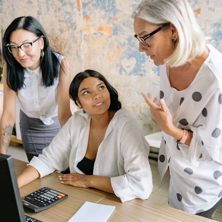 A Group Of Women Having Conversation Inside The Office