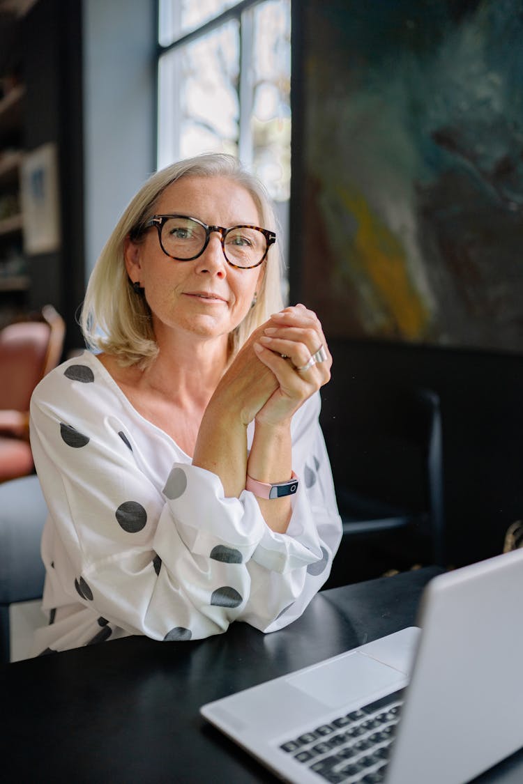 Woman In Polka Dots Top In Front Of A Laptop